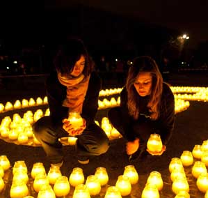 Earth Hour 2010. Two volunteers holding a candle amongst the 1600 candles. Paris, France © WWF / Nina Munn