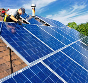 Man installing alternative energy photovoltaic solar panels on roof © iStockphoto.com / Elena Elisseeva